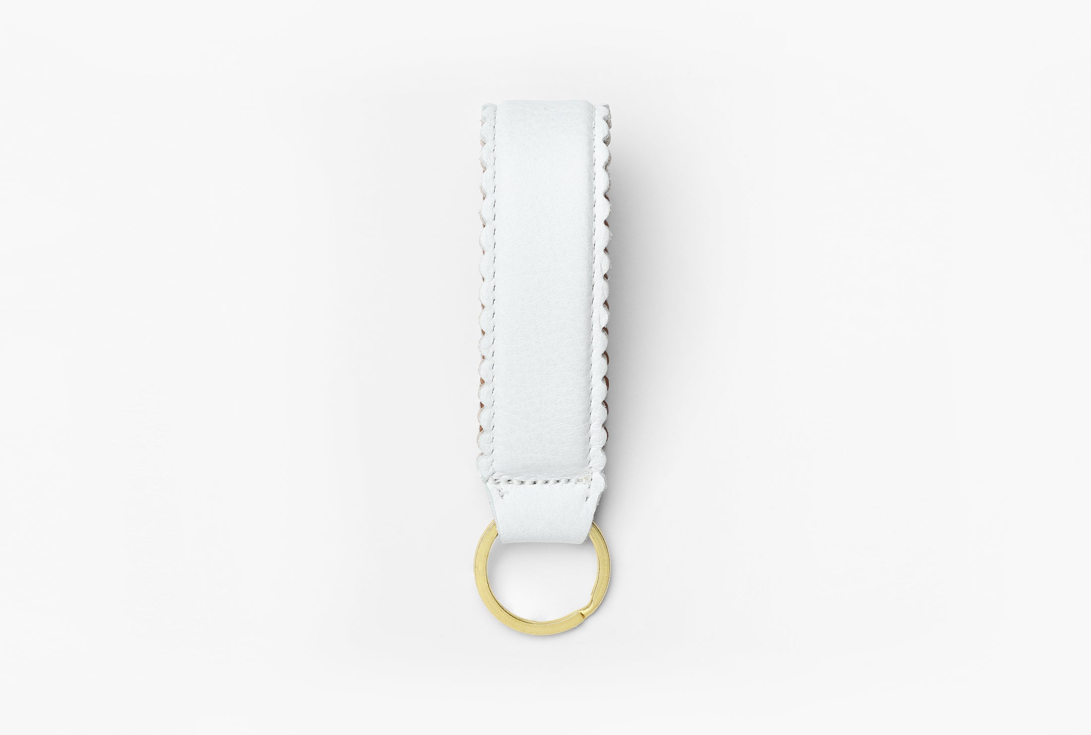 White and tan leather keychain with brass ring
