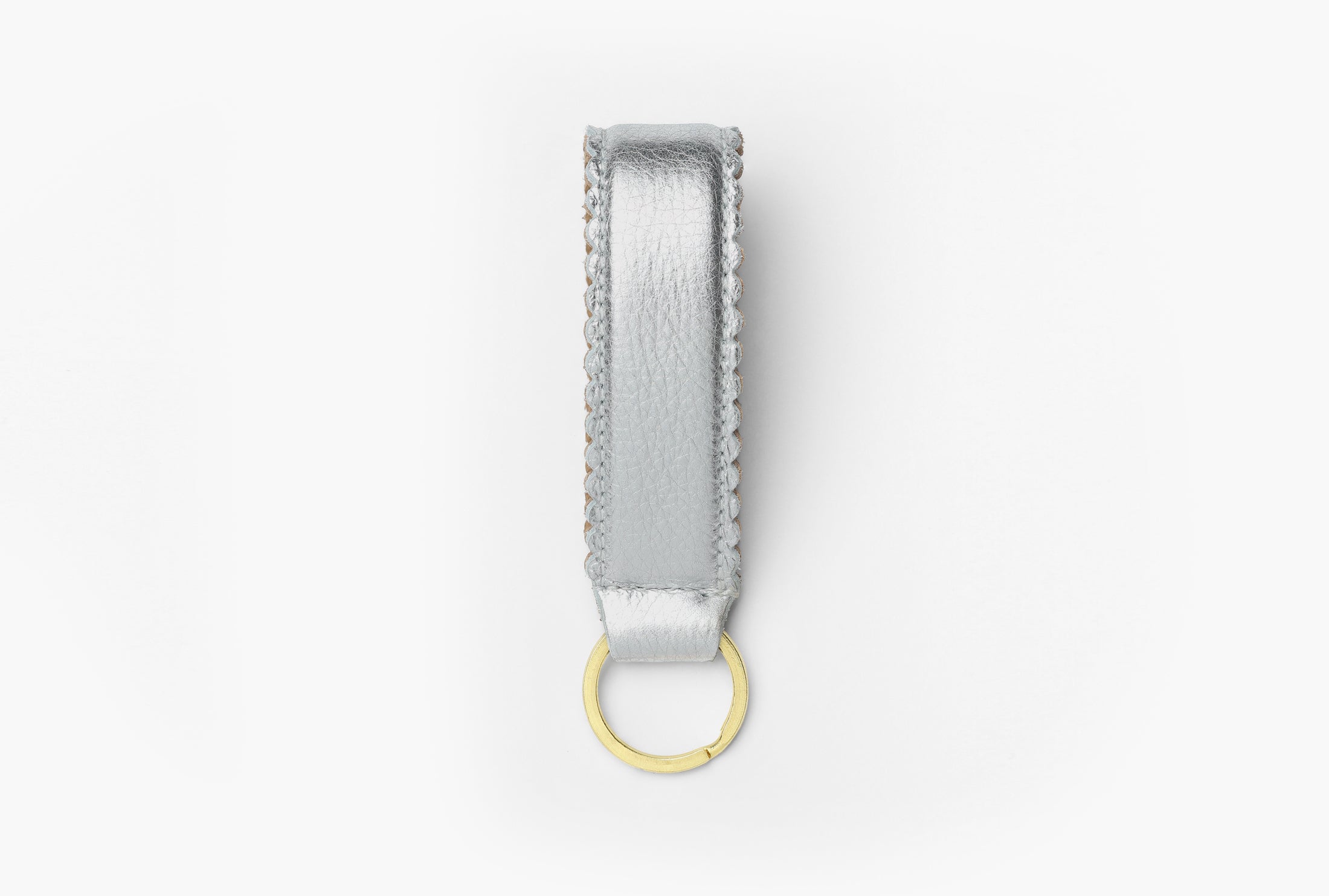 Silver and tan leather keychain with brass ring