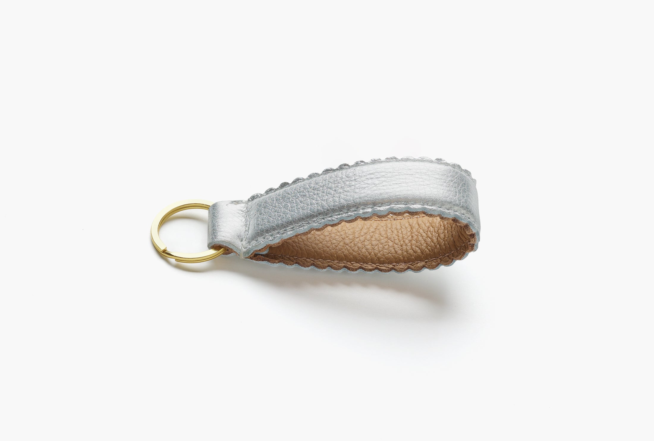 Silver and tan leather keychain with brass ring